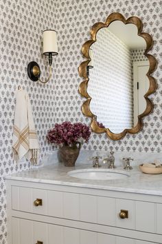 a bathroom with two sinks and a large mirror on the wall above it's counter