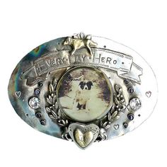 a silver belt buckle with an image of a dog on it's side and the words dear my hero