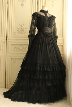 This Edwardian Style Gothic Long Dress is perfect for those looking to make a statement. It is made from a luxurious velvet fabric and adorned with beautiful Victorian lace detailing. The dress features a high neckline with a keyhole cut-out and a long flowy skirt. The full length silhouette and the intricate details make this a unique and timeless piece. The dress is perfect for any special occasion, whether it's a formal event or a night at the opera. The Edwardian Style Gothic Long Dress is Goth Edwardian Fashion, Goth Victorian Wedding Dress, Black Edwardian Dress, Black Vintage Victorian Dress, Dark Victorian Dress, Gothic Dress Outfit, Goth Victorian Dress, Goth Long Dress, Goth Dress Formal