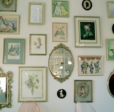 there are many framed pictures on the wall