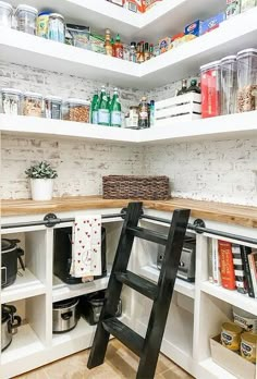 a ladder is in the middle of a kitchen with shelves full of food and drinks