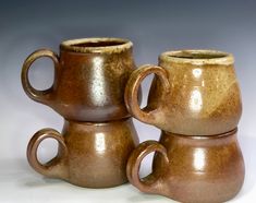 two brown cups sitting next to each other