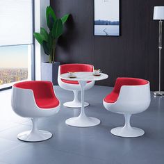 a modern dining room with red and white chairs