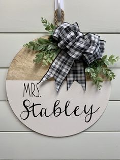 a wooden sign that says mrs stabley hanging on the side of a building