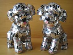 two dogs made out of newspapers sitting next to each other