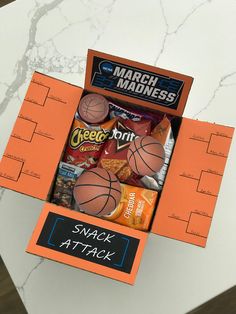 an orange box filled with snacks on top of a table