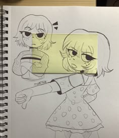 a notebook with a drawing of two girls on it