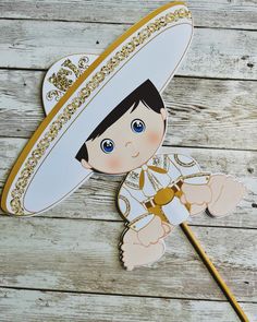 a paper cut out of a boy wearing a sombrero and holding a stick