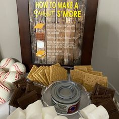 a table topped with lots of different types of food and desserts next to a framed sign