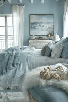 a bedroom with blue walls and white fur rugs on the floor next to a bed