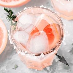 grapefruit cocktail with rosemary garnish and ice