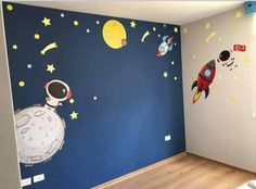 a room with blue walls and space themed wall decals