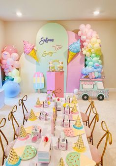 an ice cream themed birthday party with balloons and desserts on the tables in front of it