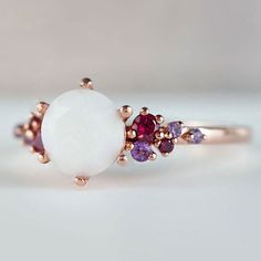 Beautiful handmade item! Here, on Etsy made as simulation only-just resin and white color.  Breastmilk Ring made with white gold plated sterling silver or plated with rose or yellow gold. Opal effect breastmik 7mm diamond shaped stone. Any size available. Rose gold,  or white gold plated options.  Pearl powder or opal effect can be added to this fine breastmilk ring.  Symbolic of the little diamond you brought into this world, our breastmilk stone ring shines bright. Beautiful inlaid cubic zirconia surround and accentuate your breastmilk stone while a skin-friendly 925 sterling silver ring core.  To see our full breastmilk Ring collection, please click here: https://www.etsy.com/ca/shop/KeepsakeMom?ref=simple-shop-header-name&listing_id=1095328032&section_id=24695275 To see All our items, White Enamel Open Ring For Anniversary, Elegant White Enamel Ring For Gift, Fine Jewelry White Cabochon Moonstone Ring, White Cabochon Moonstone Ring In Fine Jewelry Style, White Cabochon Moonstone Ring Fine Jewelry, White Moonstone Pearl Ring Gift, Unique White Multi-stone Moonstone Ring, White Moonstone Ring For Promise, Elegant White Enamel Ring For Anniversary