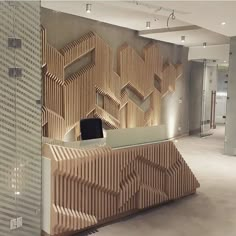 an office lobby with a large wooden wall