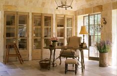 a living room filled with furniture and lots of windows