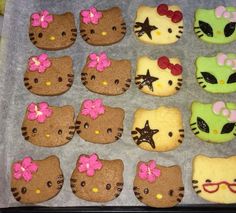 hello kitty cookies are arranged in the shape of stars and bows on a baking sheet