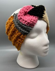 a white mannequin head wearing a knitted hat