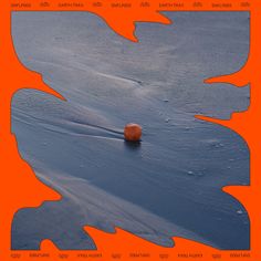 an orange ball sitting on top of ice covered ground