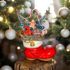 a small christmas decoration on top of a tree stump