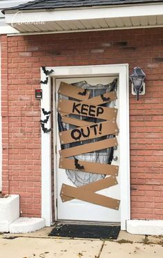 a door that has been decorated with cardboard taped to it and the words keep out