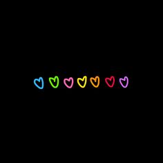 the word love is written in multicolored letters on a black background with hearts