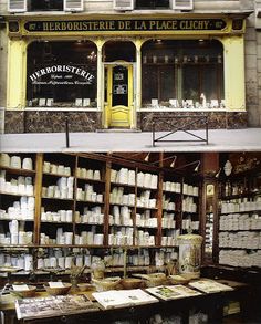 there are many shelves in front of the building with books on them and one is empty