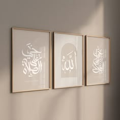 three framed art pieces hanging on a wall in an empty room with sunlight coming through the window