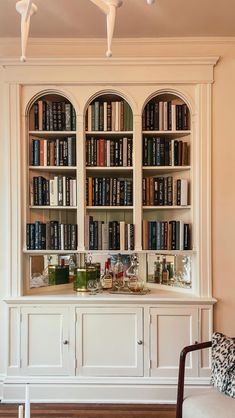 a white bookcase filled with lots of books