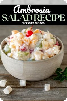 a white bowl filled with salad and marshmallows