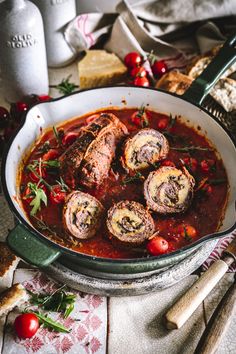 a pan filled with meat covered in tomato sauce