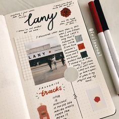 an open notebook with pictures and words on it next to a red marker, pen and paper