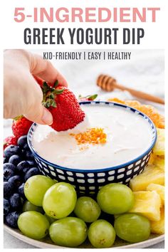 a bowl filled with yogurt, grapes and strawberries on top of a plate