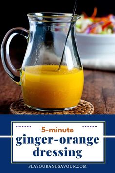 a glass pitcher filled with orange juice on top of a wooden table