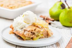 a piece of apple pie on a plate with whipped cream