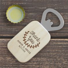 a bottle opener with a personalized message on it next to an empty beer bottle