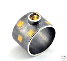 This is aring from our Tetris Collection. It is made of oxidized silver, 24 k gold and a 5 mm round Citrine gemstone. We use the Korean technique Keum boo to fuse 24 k gold with silver only by applying heat with the torch. The ring is 11 mm wide and  weighs about 9 grams. Available Ring sizes: Size 4 1/2 US - 76 ( 13 1/2) You can find matching earrings, bracelets and pendants in our shop. All es Jewelry products are shipped with our beautiful, branded packaging. Gold And Silver Ring, Keum Boo, Contemporary Ring, Gold And Silver Rings, Citrine Ring, Ring Black, Citrine Gemstone, Branded Packaging, Oxidized Silver