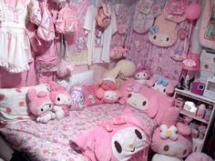 a bedroom with hello kitty bedding and stuffed animals