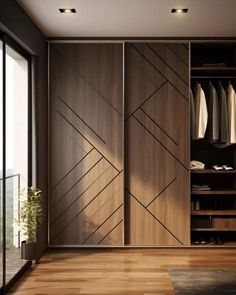 an open closet with sliding doors and wooden flooring