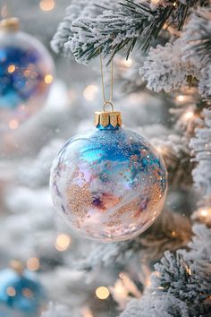 a christmas ornament hanging from the side of a tree with snow on it