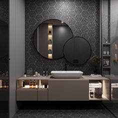 a bathroom with a sink, mirror and lights on the wall above it's counter