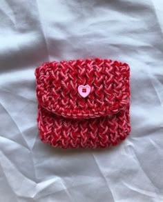 a red crocheted wallet with a pink heart on it