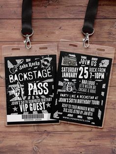 two luggage tags with black and white designs on them are attached to a wooden background