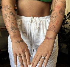 a woman with tattoos on her arms and hands