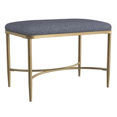 an upholstered bench with gold frame and blue fabric