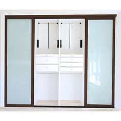 an empty room with two white closets next to each other, and the doors are open