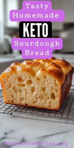 a loaf of keto sourdough bread on a cooling rack with the words, tasty homemade keto sourdough bread