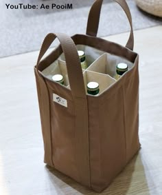 a brown tote bag with six bottles in it