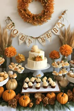 a table topped with lots of cupcakes and cakes