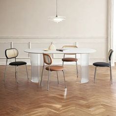 a white table with four chairs around it